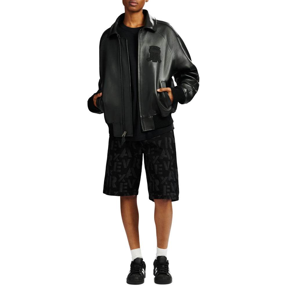 Full-length streetwear styling of black Avirex Iconic leather bomber with solid knit cuffs and roomy blouson shape