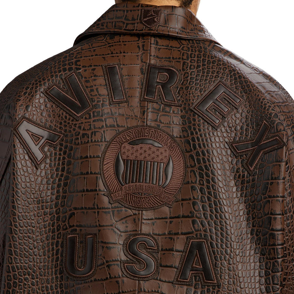 Close-up of dimensional AVIREX USA back appliqués and circular shield on embossed brown leather