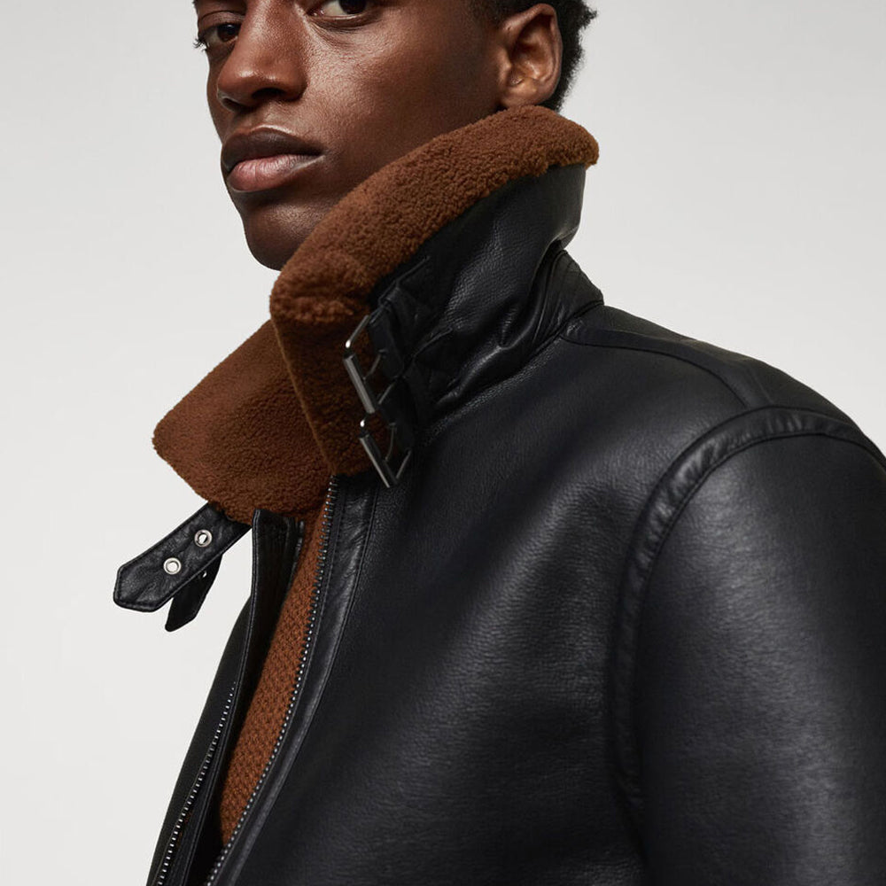 Close up detail of B3 aviator jacket upright collar featuring twin leather neck straps and metal roller buckles
