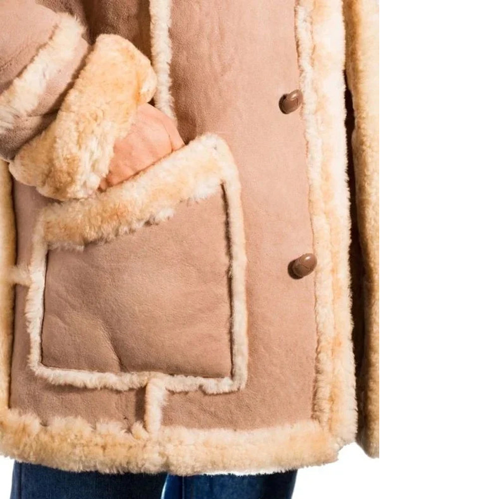 Close-up of shearling-trimmed front pocket and snap button closures on beige sheepskin Rancher Shearling Jacket