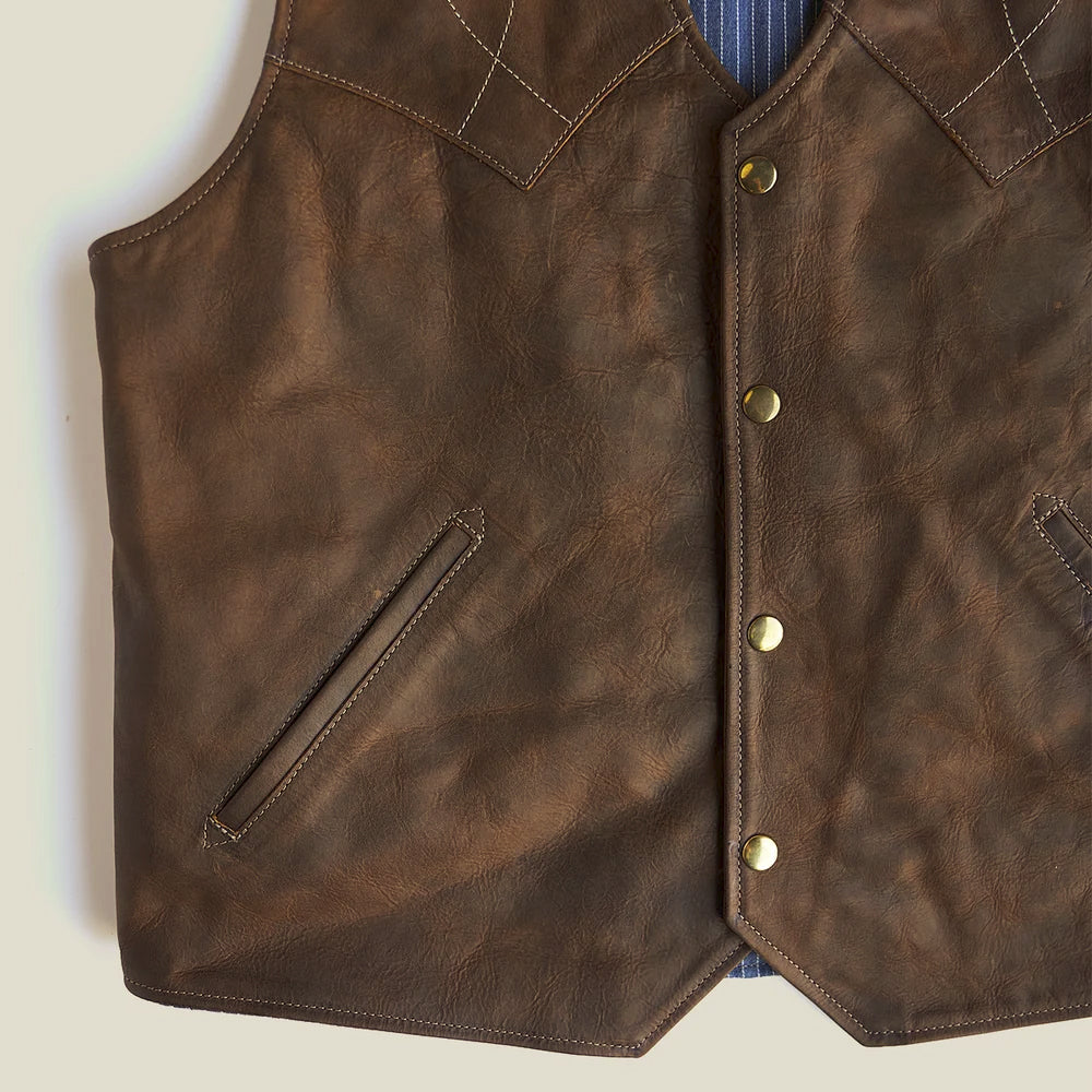 Distressed bison leather texture with antique coin-style snaps and an angled leather-trimmed welt pocket