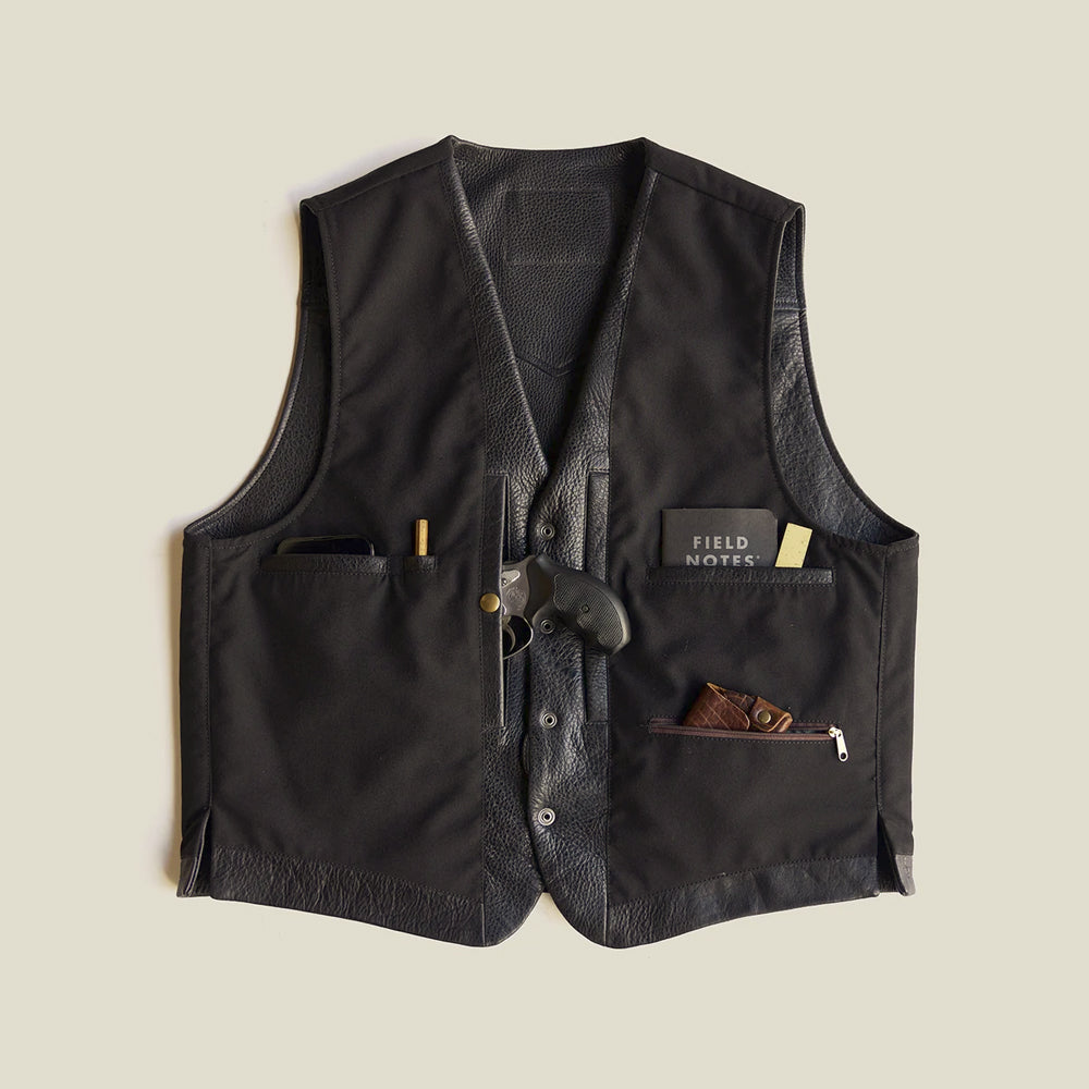 Open interior of black bison CCW vest displaying dual concealed-carry compartments, wallet pockets and zippered storage
