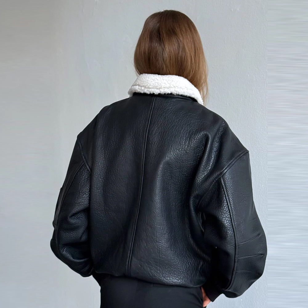 Back detail of women’s oversized black cow leather bomber jacket