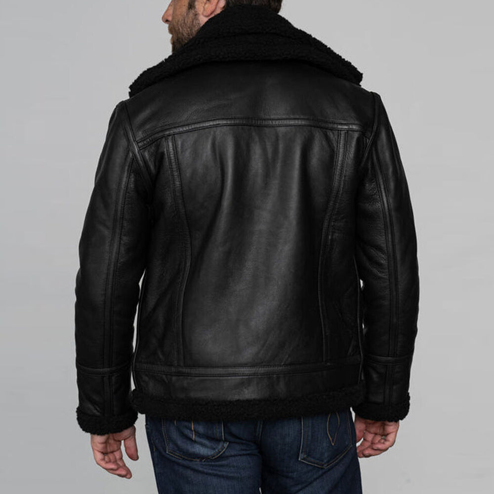 Back panel view of model wearing black grain leather shearling coat displaying multi panel yoke construction