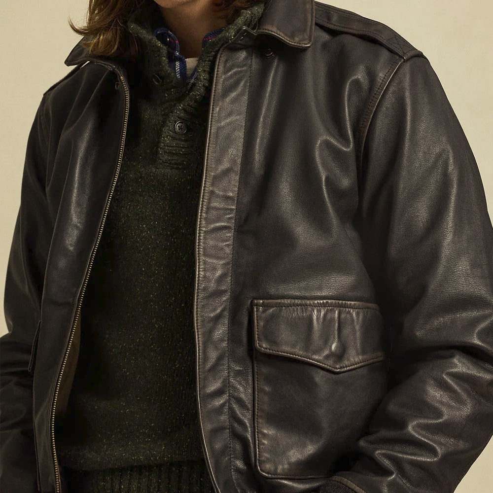 Close model view of black lambskin bomber with point collar, covered YKK zipper and lower cargo pocket