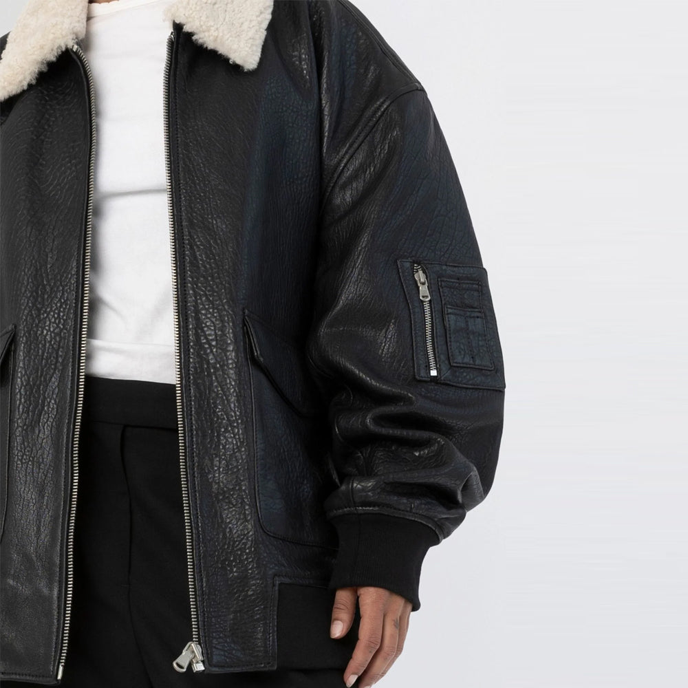 Close-up of black leather bomber jacket zipper and zipped sleeve utility pocket