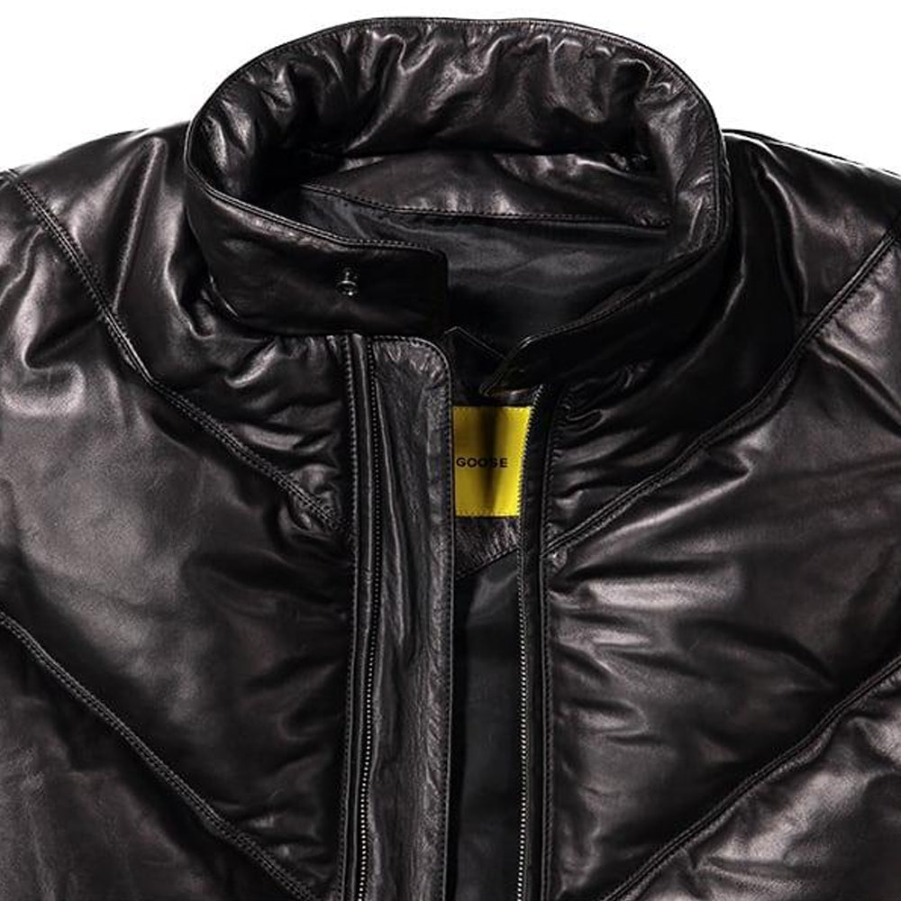 Close-up of padded stand collar, storm guard, antique-brass zipper and yellow woven neck label