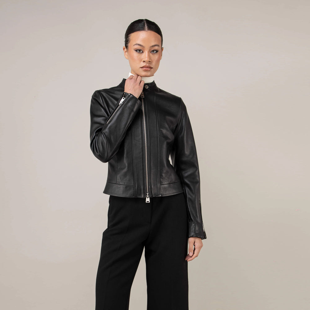 Waist-up view of black leather racer jacket with sleek stand collar and zip cuffs
