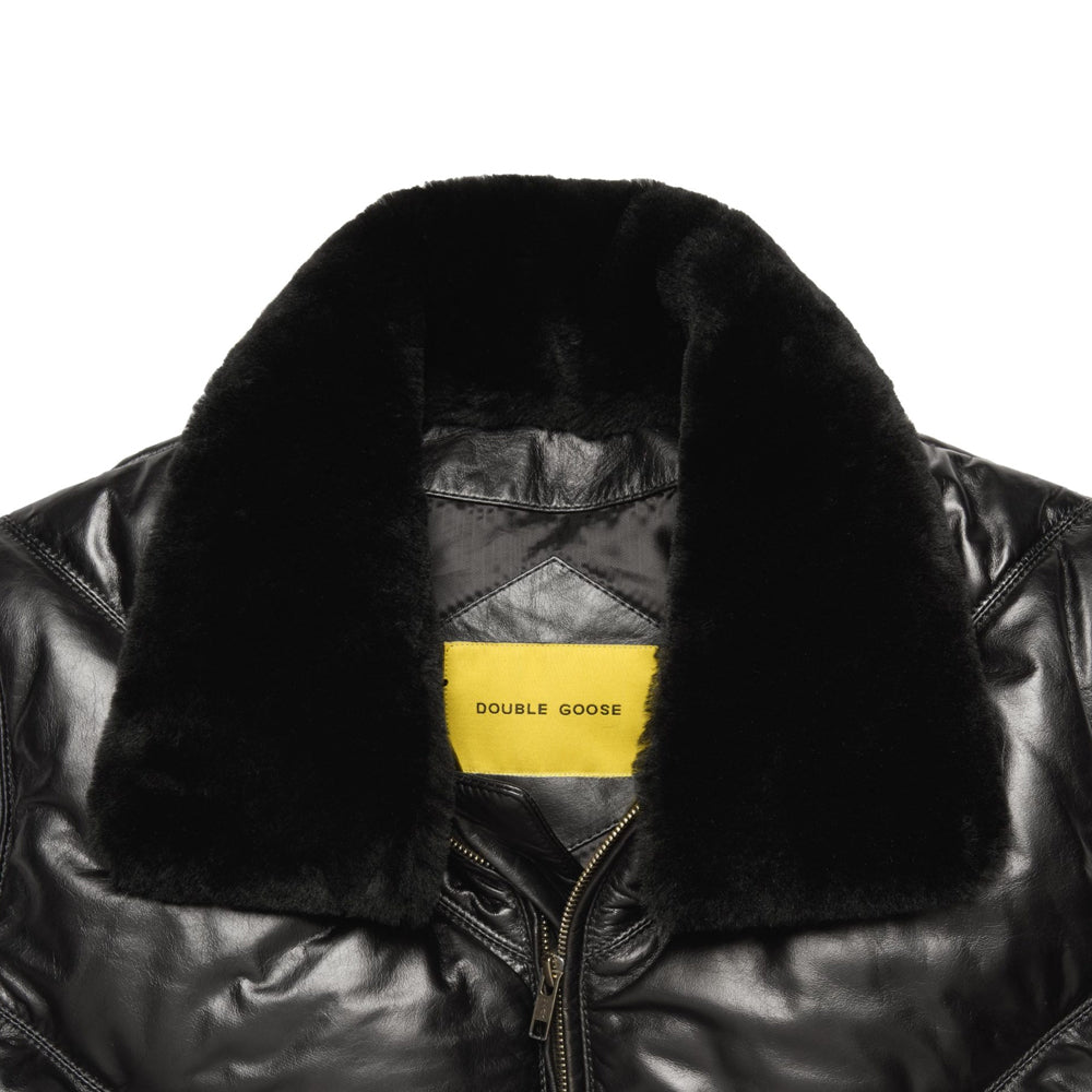 Close-up shot of detachable black shearling fur collar and yellow Double Goose woven neck label inside black lambskin puffer.