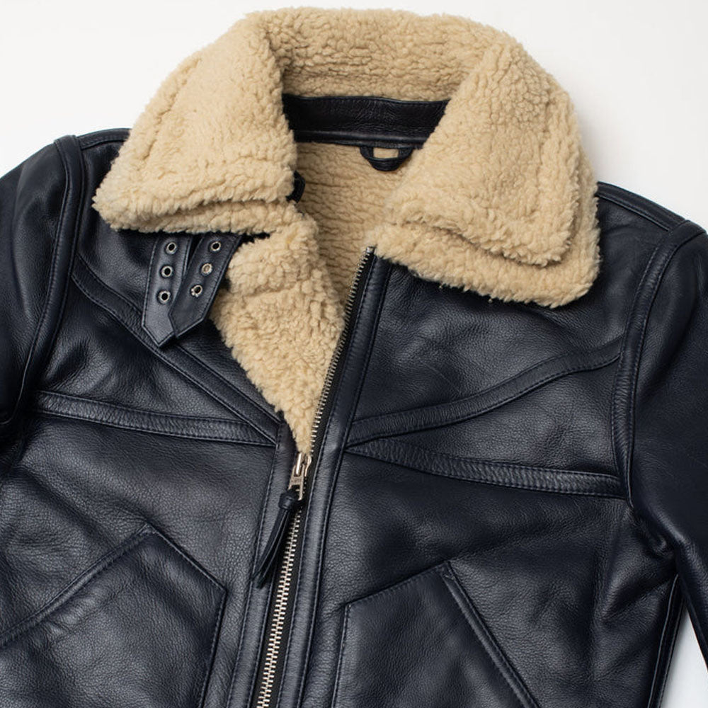 Close-up of smooth grain black sheepskin leather featuring angular chevron chest panel stitching