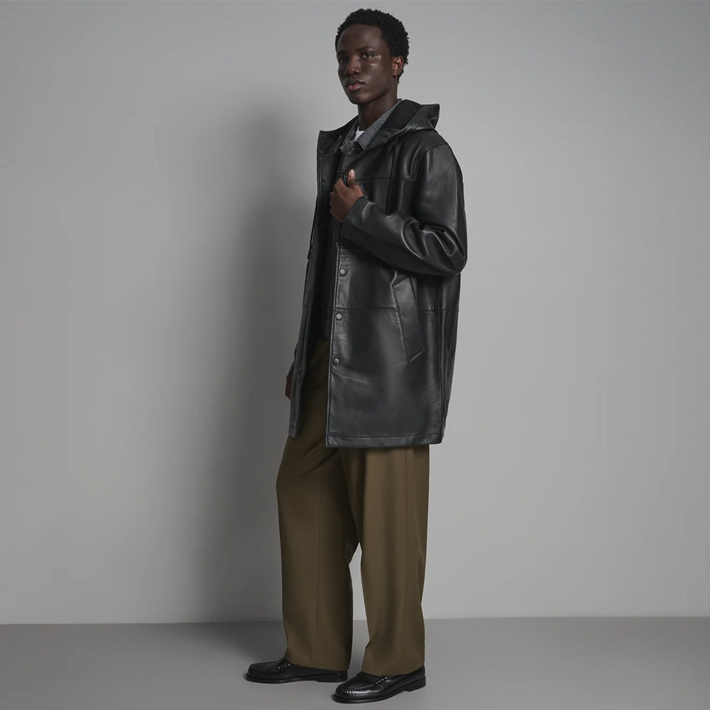 Side view of black snap-front leather anorak for men showing smooth shell, straight sleeve and angled welt pocket.