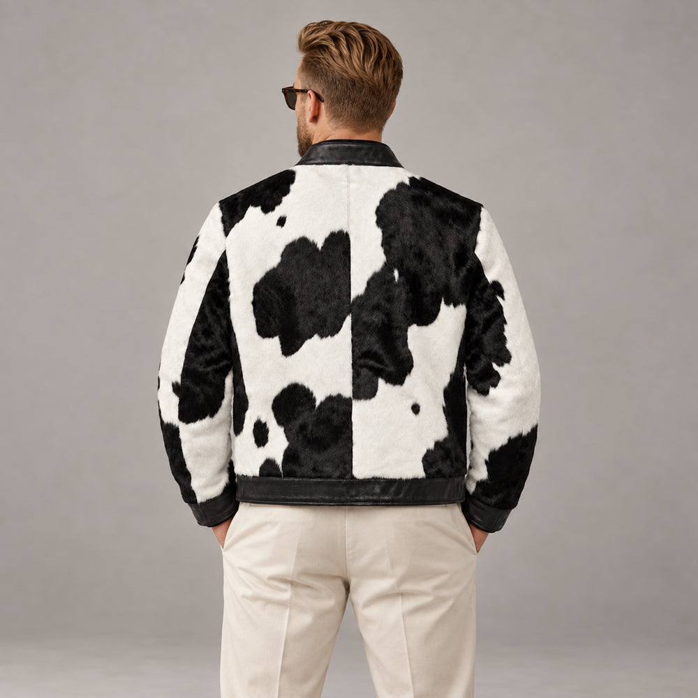 Model back view of black and white cowhide racer jacket with broad natural hide panels