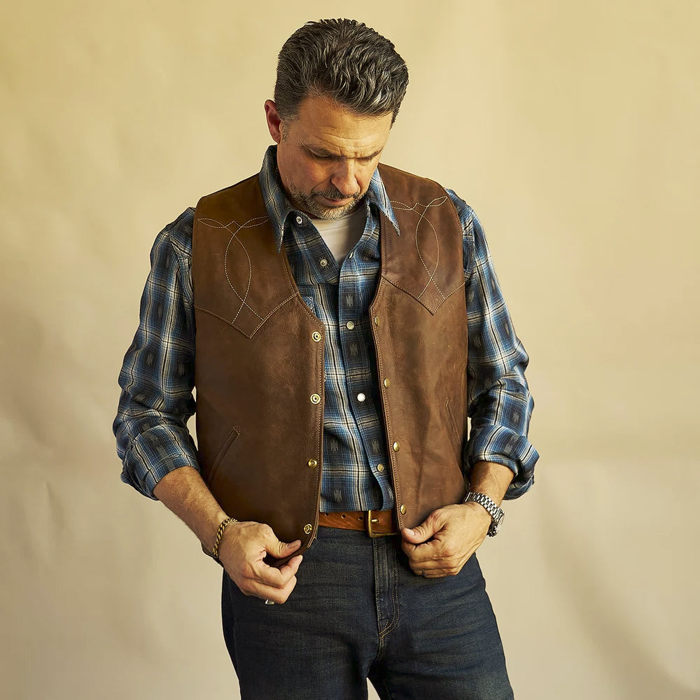 Men’s distressed brown bison ranch vest displaying its V-neckline, snap front and pointed lower hem