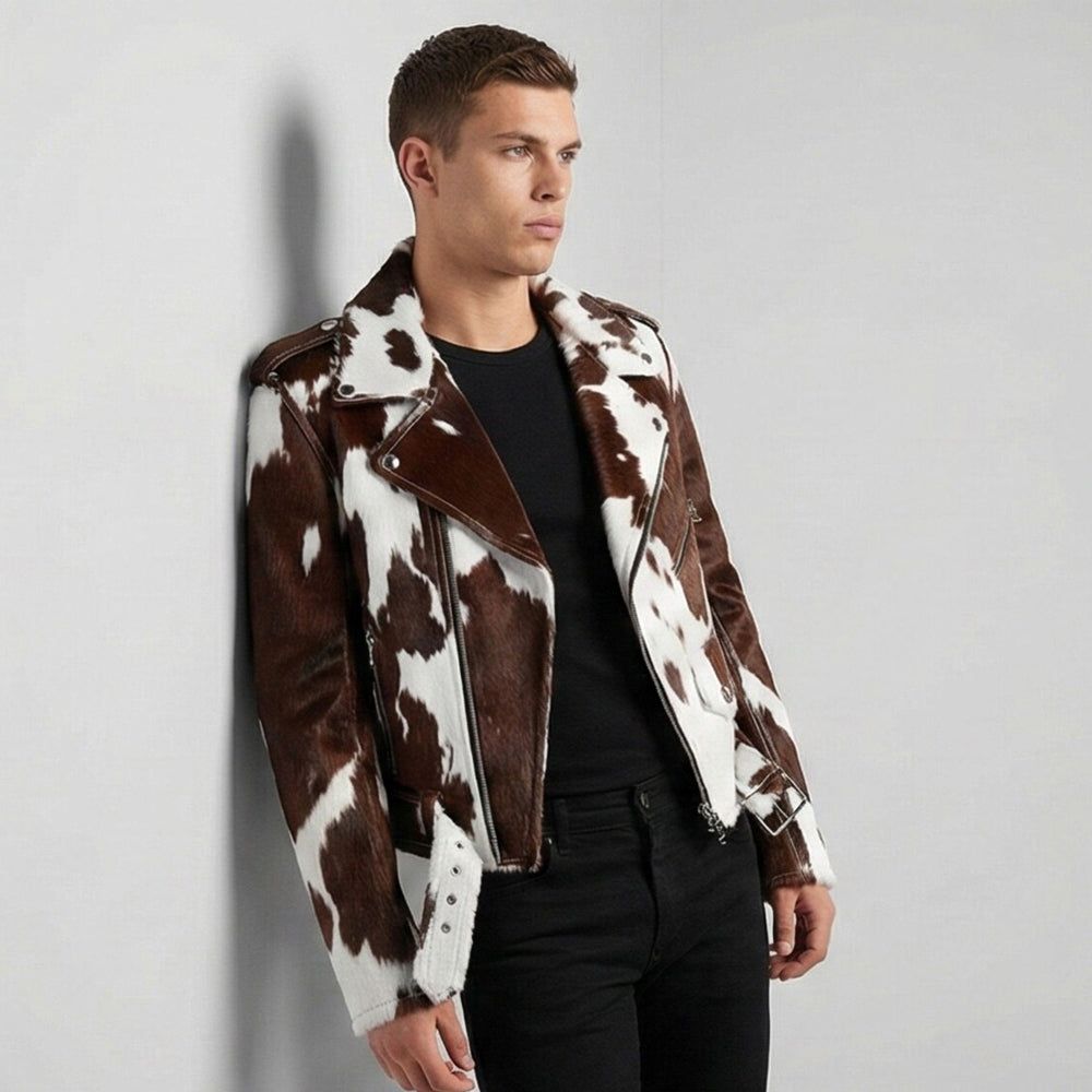 Model wearing a brown and white cowhide moto jacket with snap lapels and shoulder epaulettes