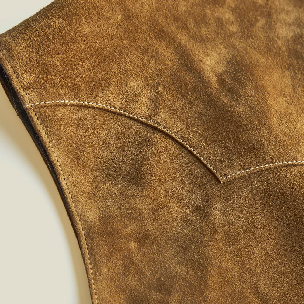 Macro detail of fine brushed cow suede, curved Western yoke construction and precise light-brown stitching