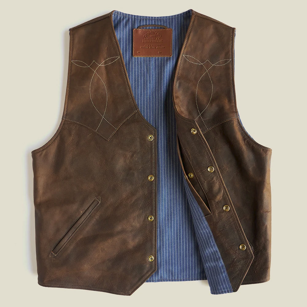 Open brown bison leather vest revealing blue pinstriped chambray lining and snap-front construction
