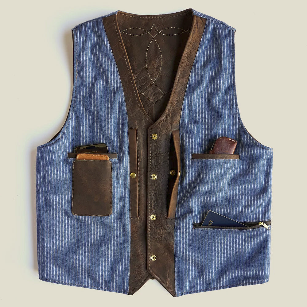 Blue chambray-lined Western vest interior with leather-trimmed wallet, utility and zippered pockets