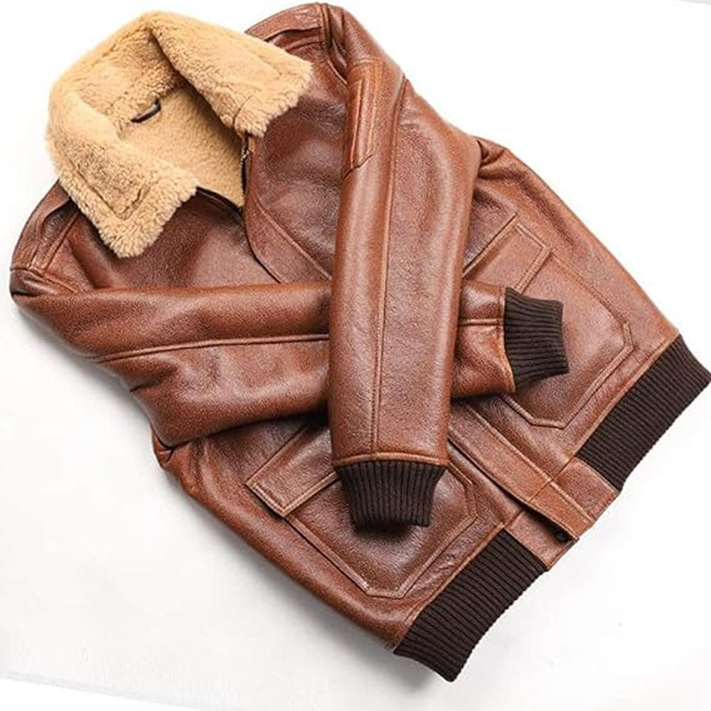 Folded view of cognac shearling bomber coat showing dark brown stretch ribbed knit cuffs and waist hem