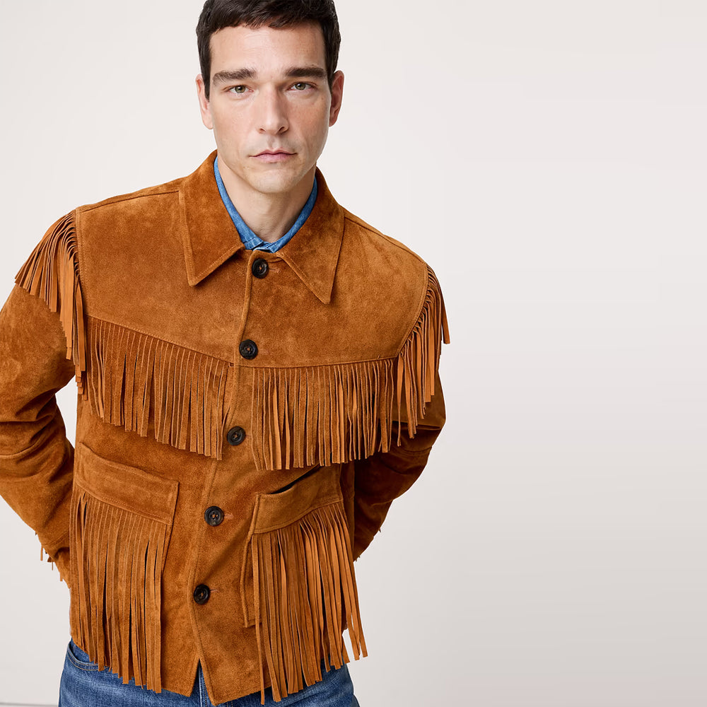 Three-quarter view of cognac suede rodeo jacket for men with point collar, marbled button closure and layered chest fringe.