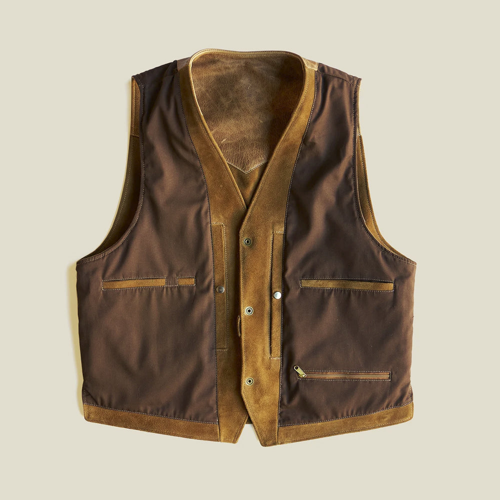 Interior view of the cotton-lined tan suede vest showing multiple storage compartments and a zippered inner pocket