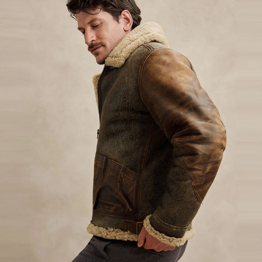 Side profile of model wearing crackled shearling aviator jacket showing two tone cognac leather sleeve panels