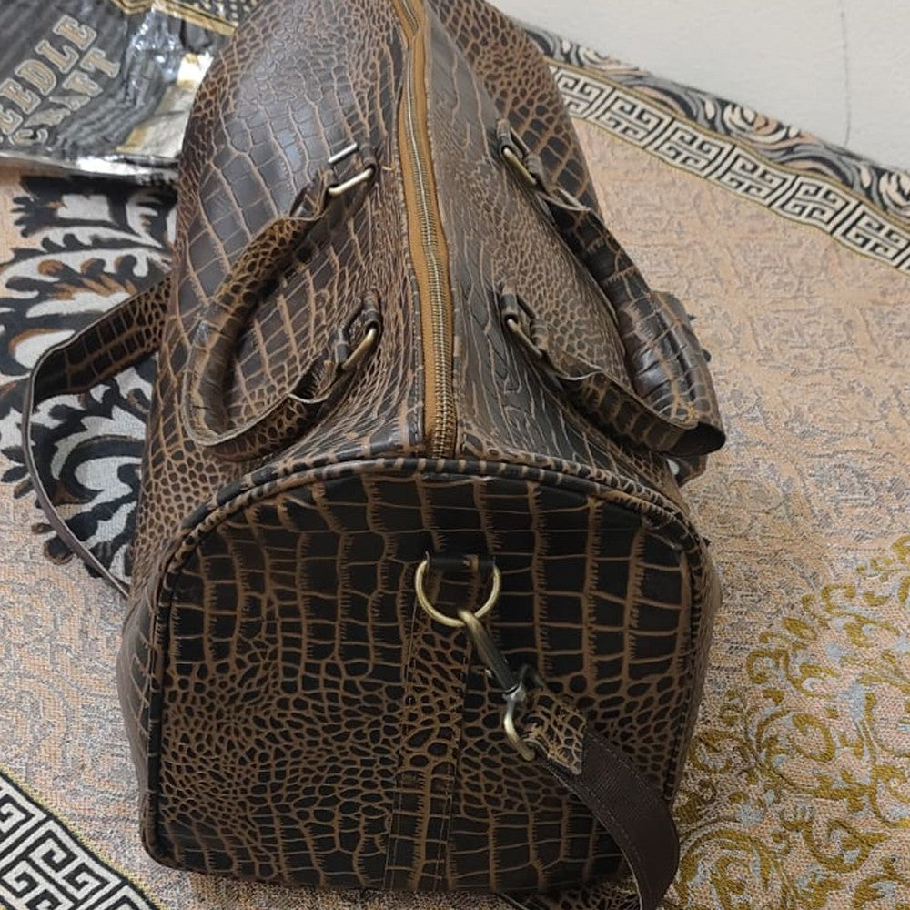 Side profile of the premium croc leather duffle bag showing metal hardware and detachable strap clasp