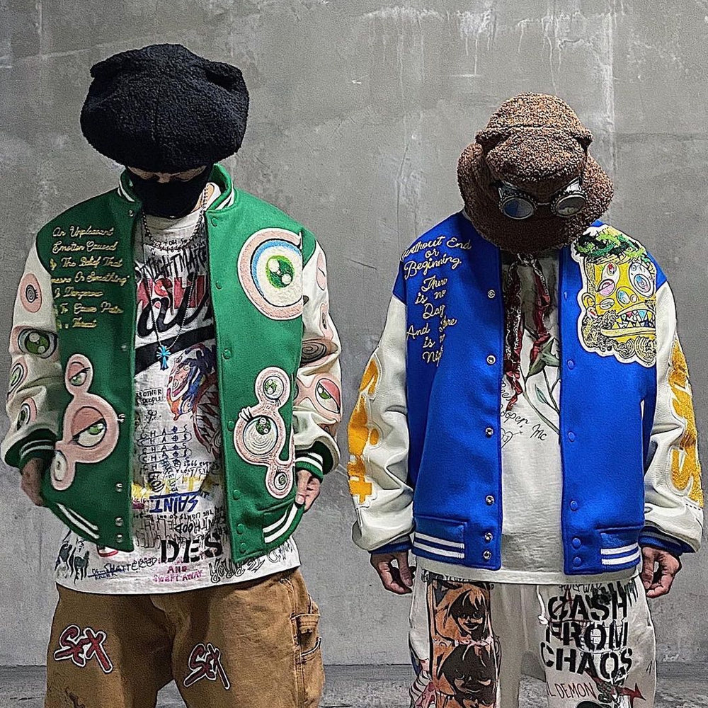 Full streetwear styling of the blue Eternal Youth varsity jacket paired with matching graphic pants, highlighting the authentic white leather sleeves.