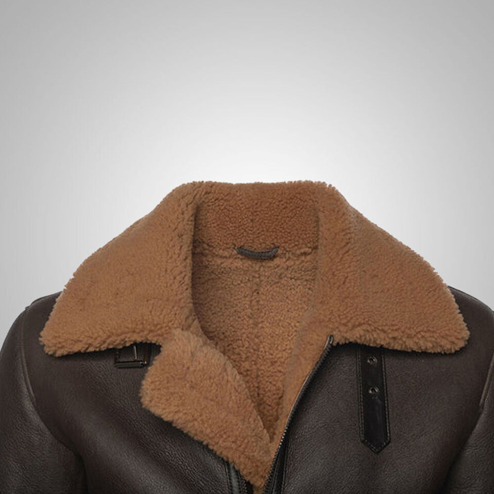 Close up view of tan camel shearling lapel collar and dark leather throat latch on dark brown B3 aviator jacket