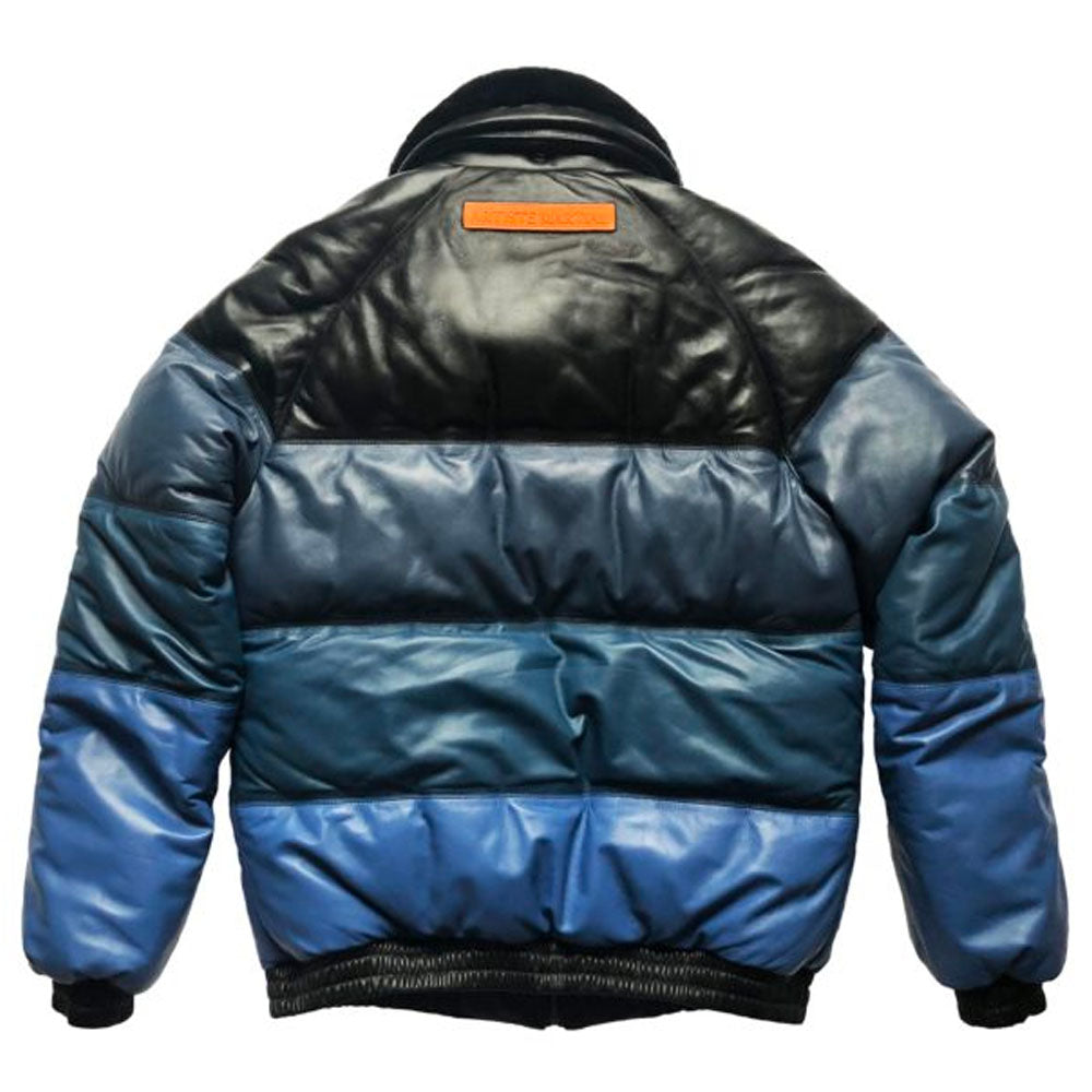 Rear close-up of the custom orange leather debossed patch on the waistband of the blue gradient bomber.