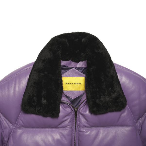 Macro close-up view focusing on the thick texture of the detachable black sheep wool collar trim.