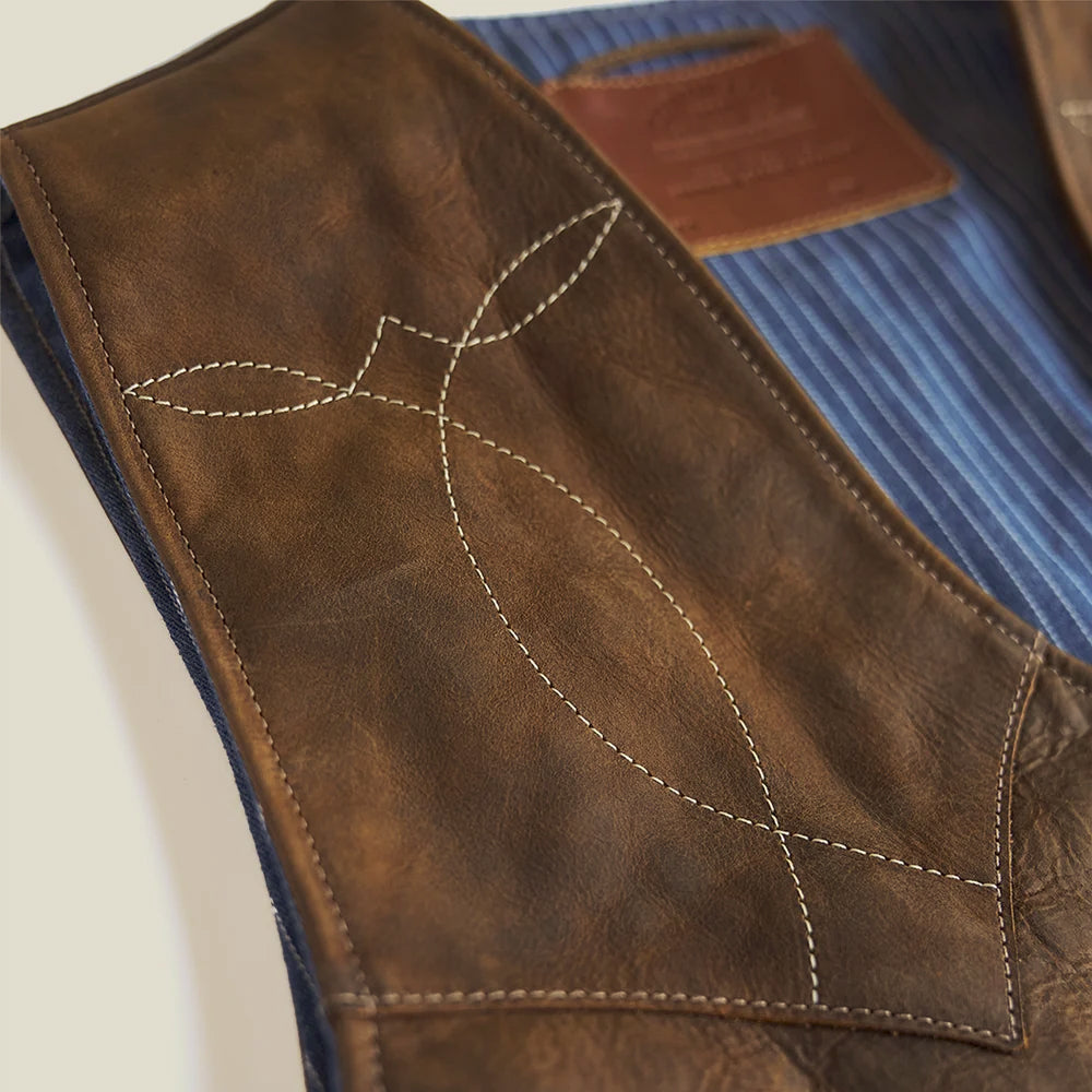 Detailed diamond-and-leaf Western topstitching on the distressed American bison leather yoke