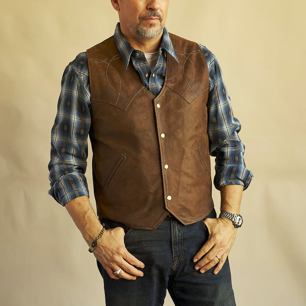 Men wearing a distressed brown American bison Western vest closed over a blue plaid shirt
