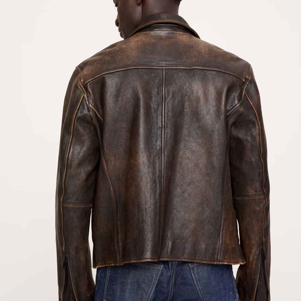 Rear view of distressed brown café racer–inspired jacket with shoulder yoke, center seam and curved side-back panels