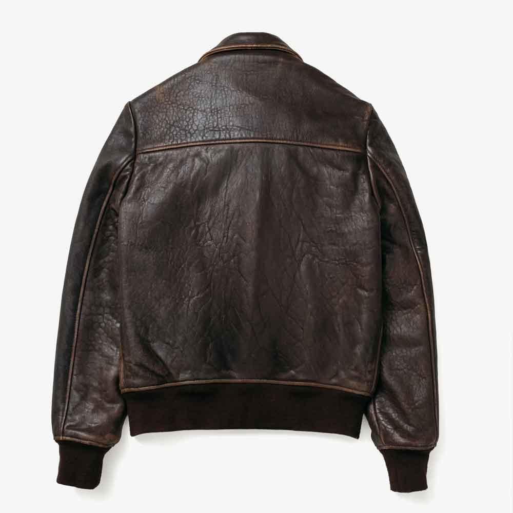 Rear flat view of distressed brown leather bomber showing wide shoulder yoke, plain center back and rib-knit waistband