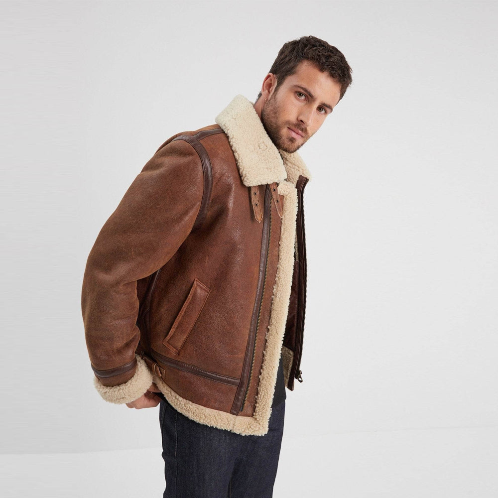 Angled view of men’s distressed brown shearling aviator jacket revealing the cream fleece interior and slanted welt pocket