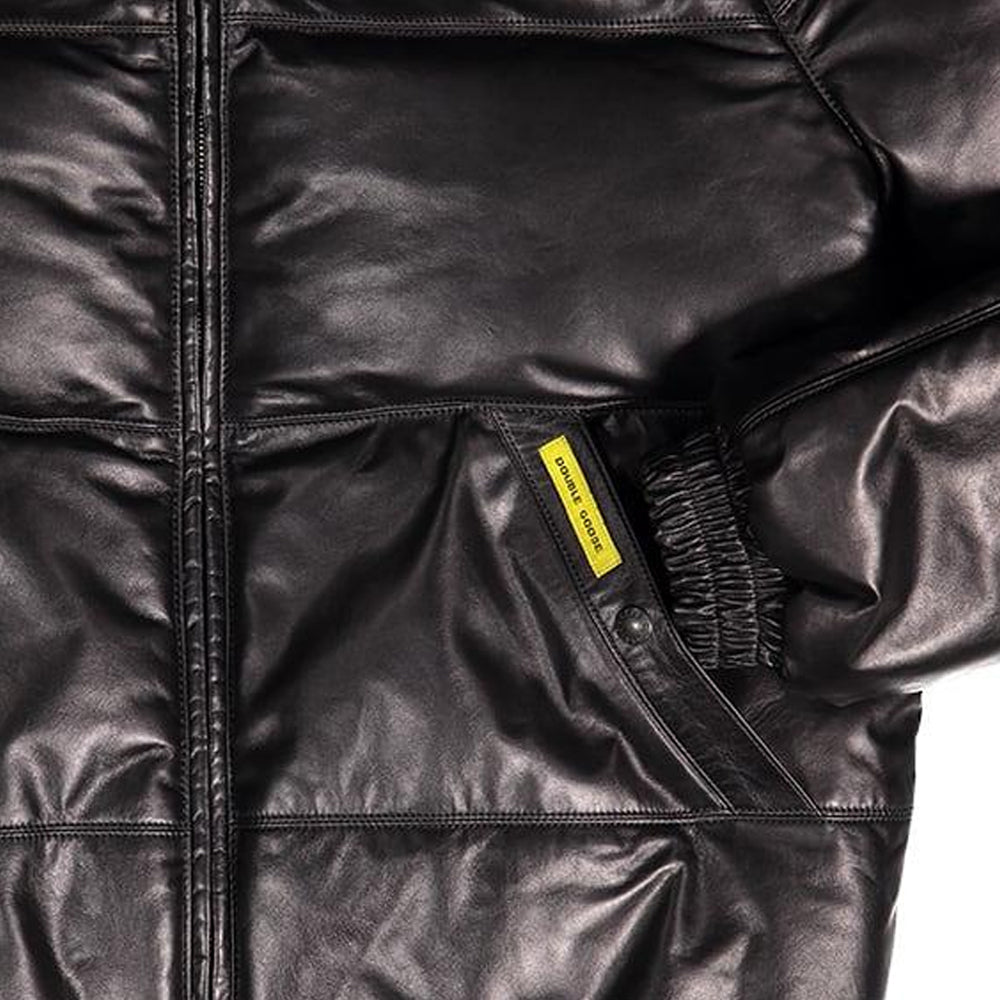 Detail shot of black leather jacket welt pocket with yellow Double Goose branded tag