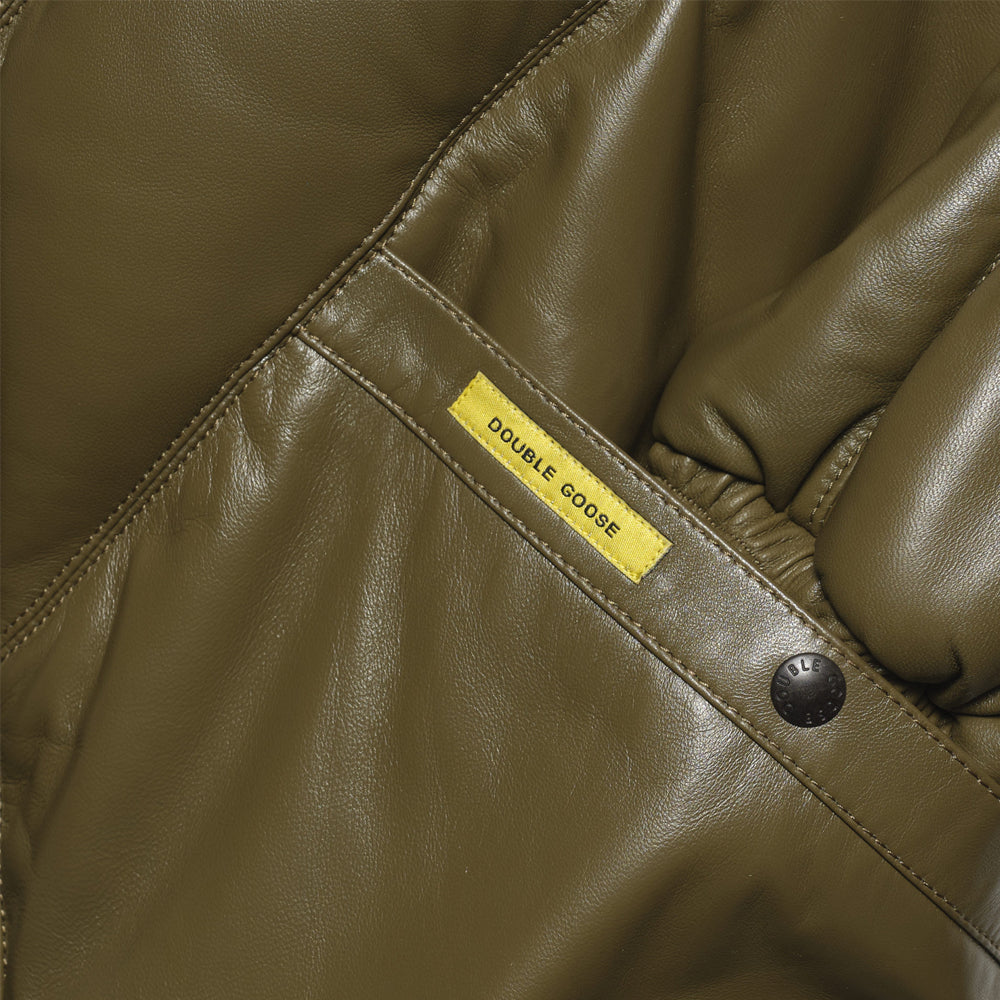 Close-up of Double Goose leather jacket's welt hand-warmer pocket with branded snap closure and label
