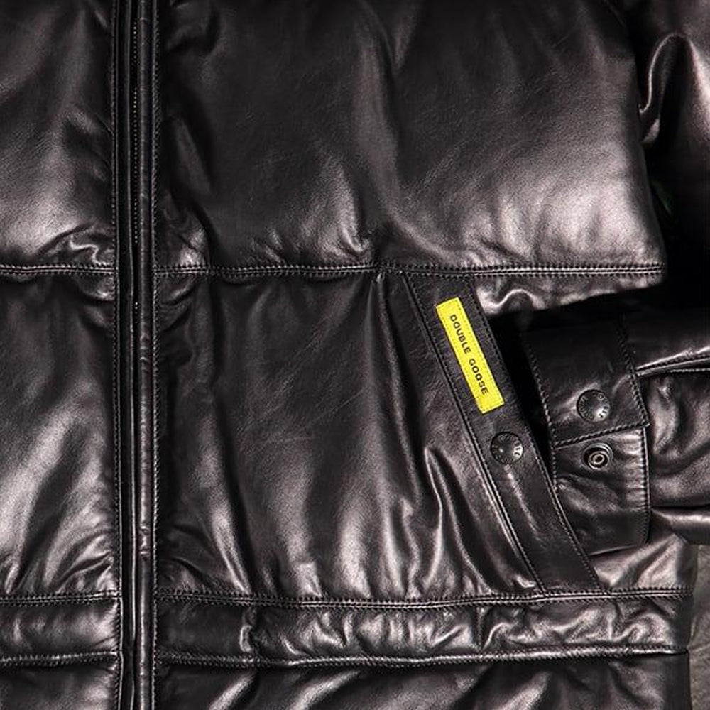 Close-up of Double Goose leather down parka pocket with woven brand tab and snap cuff