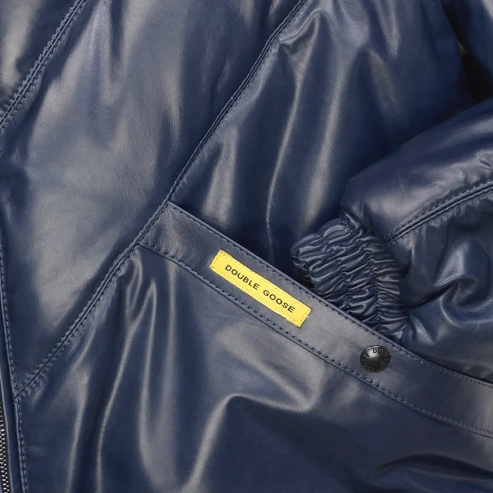 Close-up of Double Goose navy leather jacket pocket with brand tab and elasticated cuff