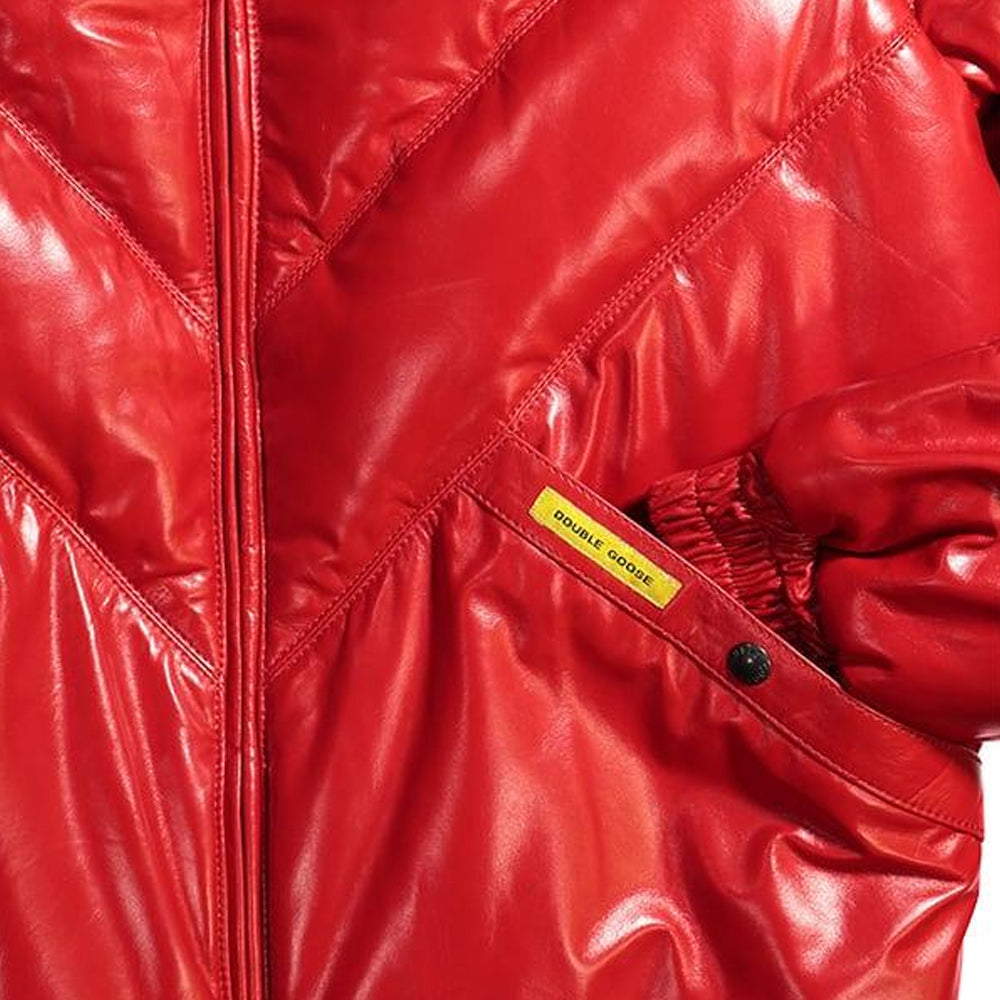 Macro view of angled handwarmer welt pocket with yellow Double Goose woven label on red leather.