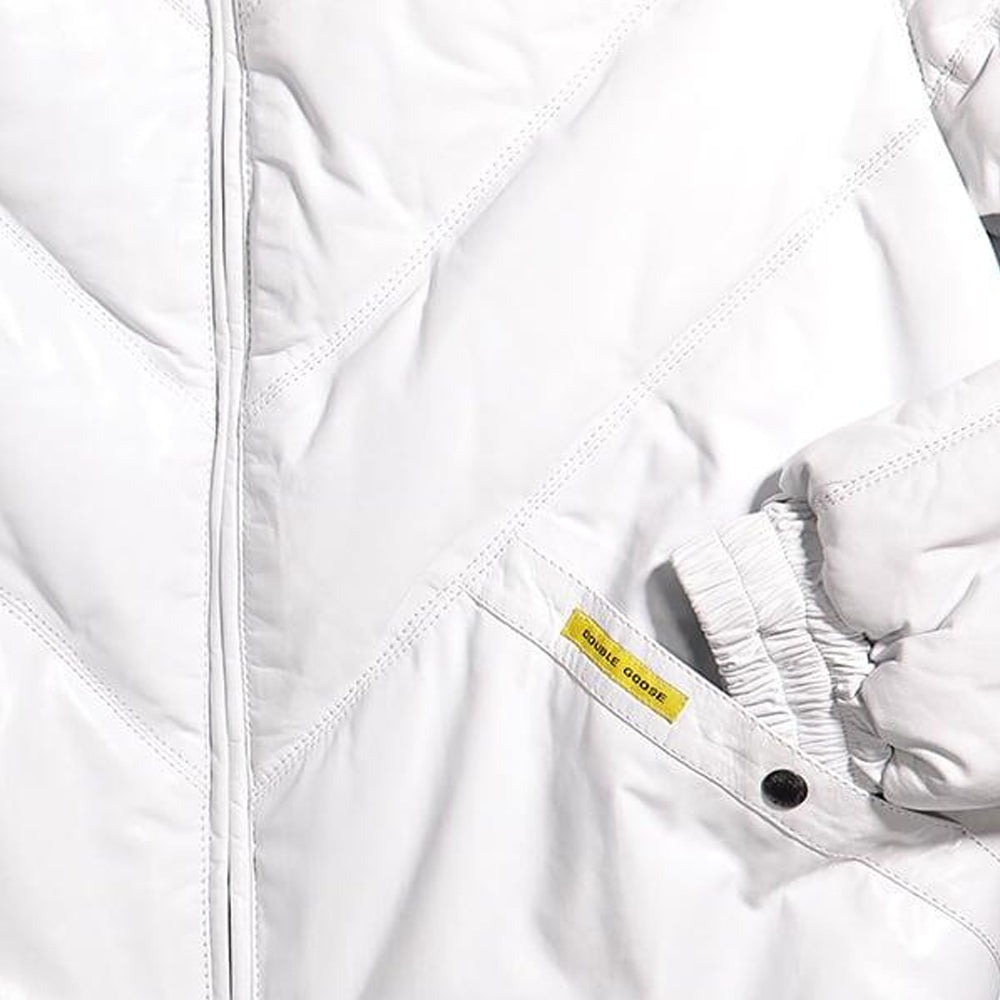 Detail shot of white leather jacket welt pocket with yellow Double Goose branded tag and ribbed cuff