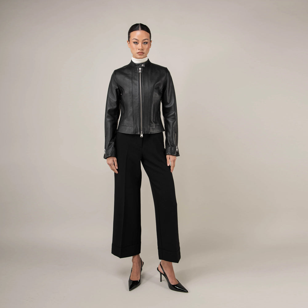 Full-length front styling of fitted black lambskin jacket with wide-leg trousers