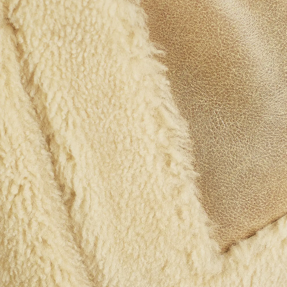 Close-up of genuine tan suede and curly ivory shearling wool textures