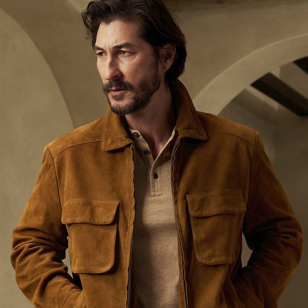 Close front view of the golden tobacco suede workwear jacket highlighting its point collar and symmetrical flap pockets