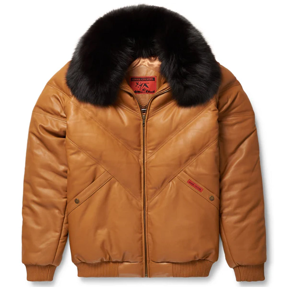 Front profile view of the Goose Country men's camel tan leather V-bomber jacket showcasing the chevron puffer panels and black fur collar.