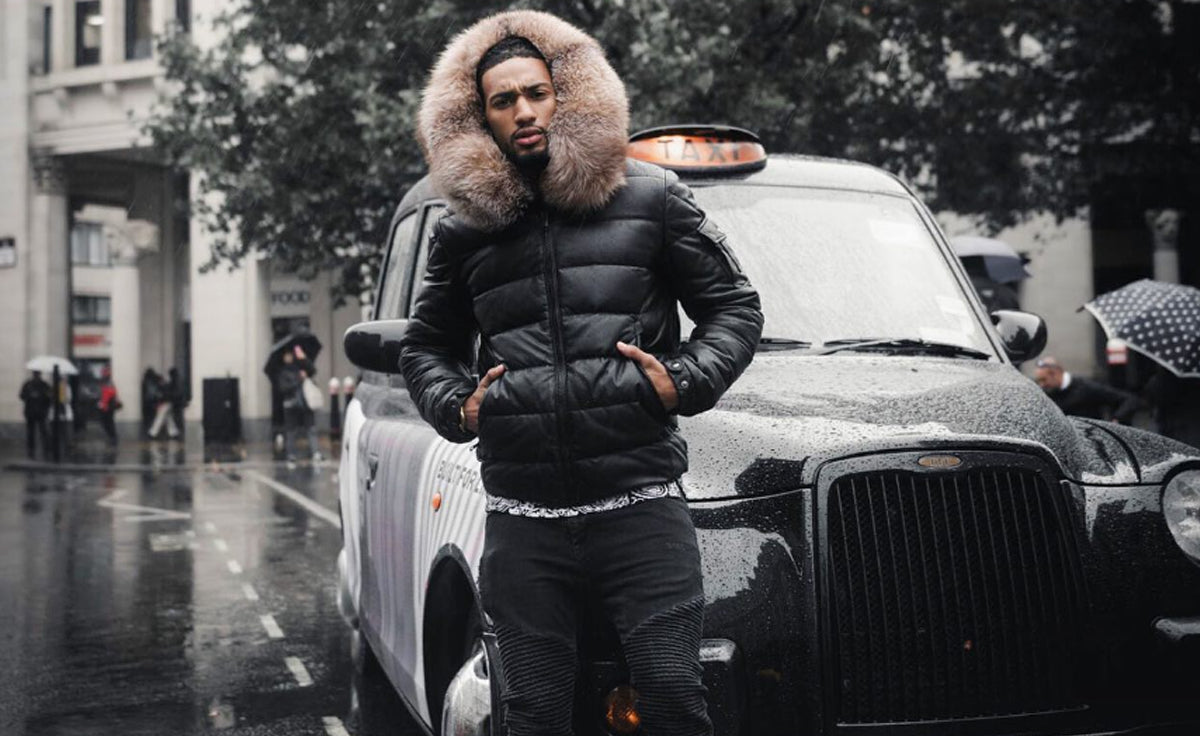 Man wearing black leather V-bomber jacket with fur-trimmed hood, Goose Country collection, London street style