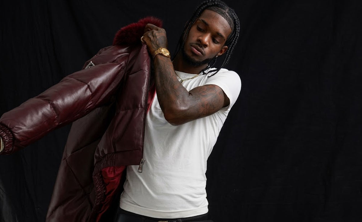 Man wearing burgundy leather V-bomber jacket with fur-trimmed collar, Goose Country collection