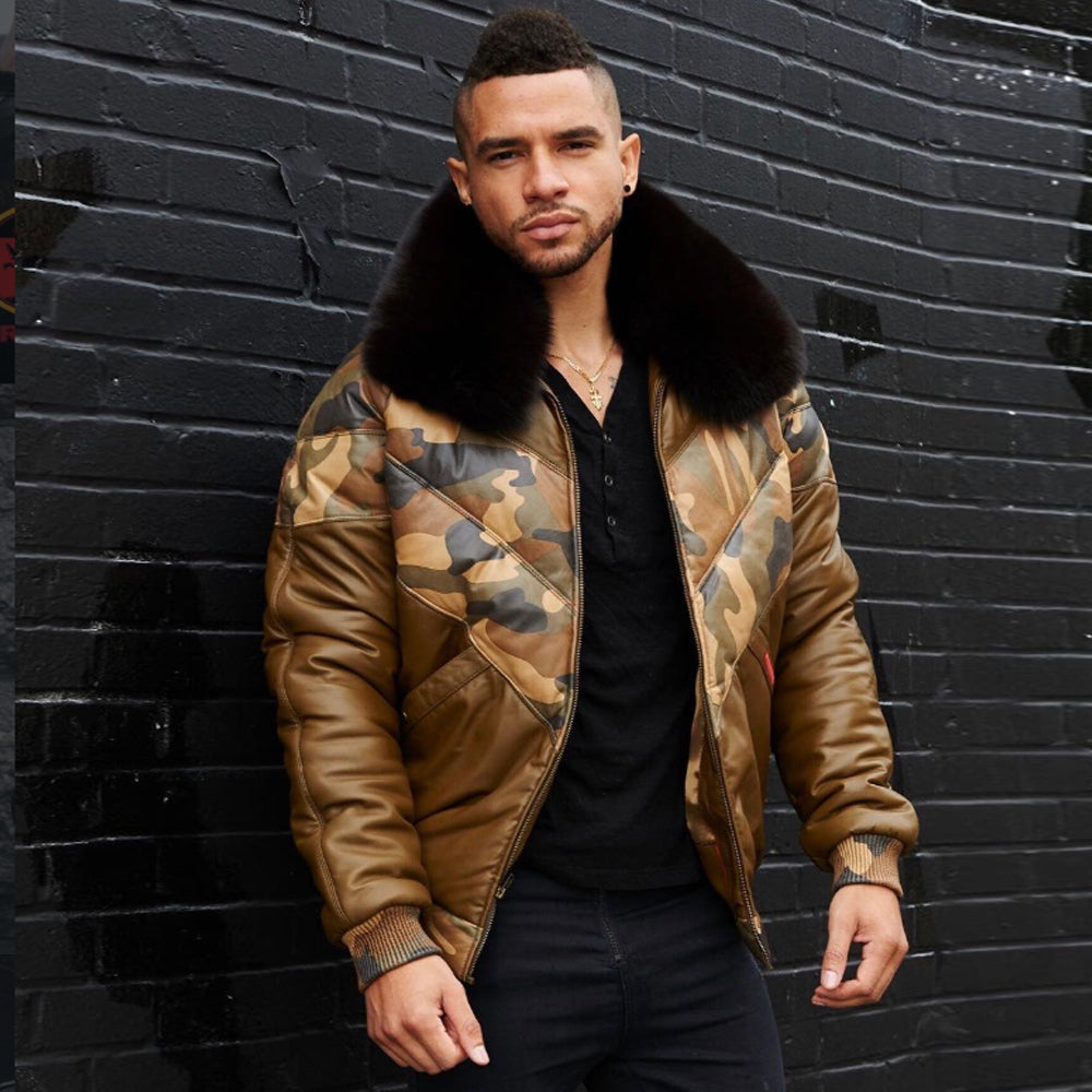 Man wearing camo leather V-bomber jacket with black fox fur collar against brick wall