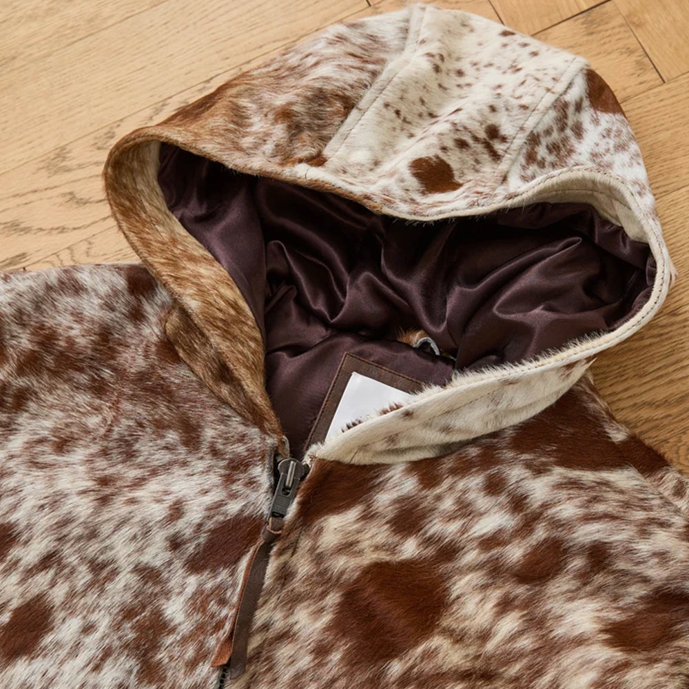 Close-up of the multi-panel hair-on cowhide hood with smooth brown viscose lining and natural cream markings