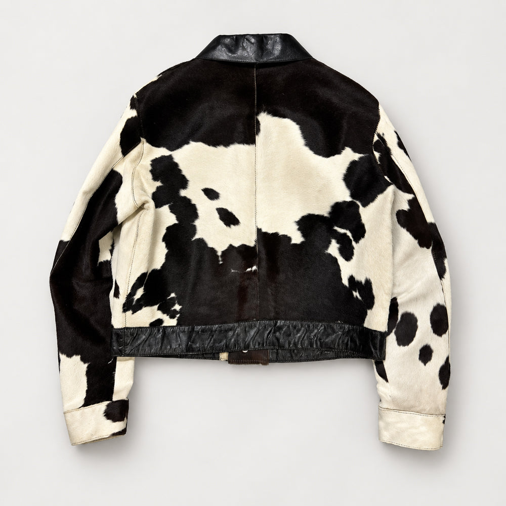 Back view of hair-on-hide Western snap jacket showing tricolor cowhide, yoke seam and leather hem